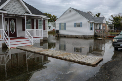 The arrival of high tide also means the temporary submergence of this home’s front yard.